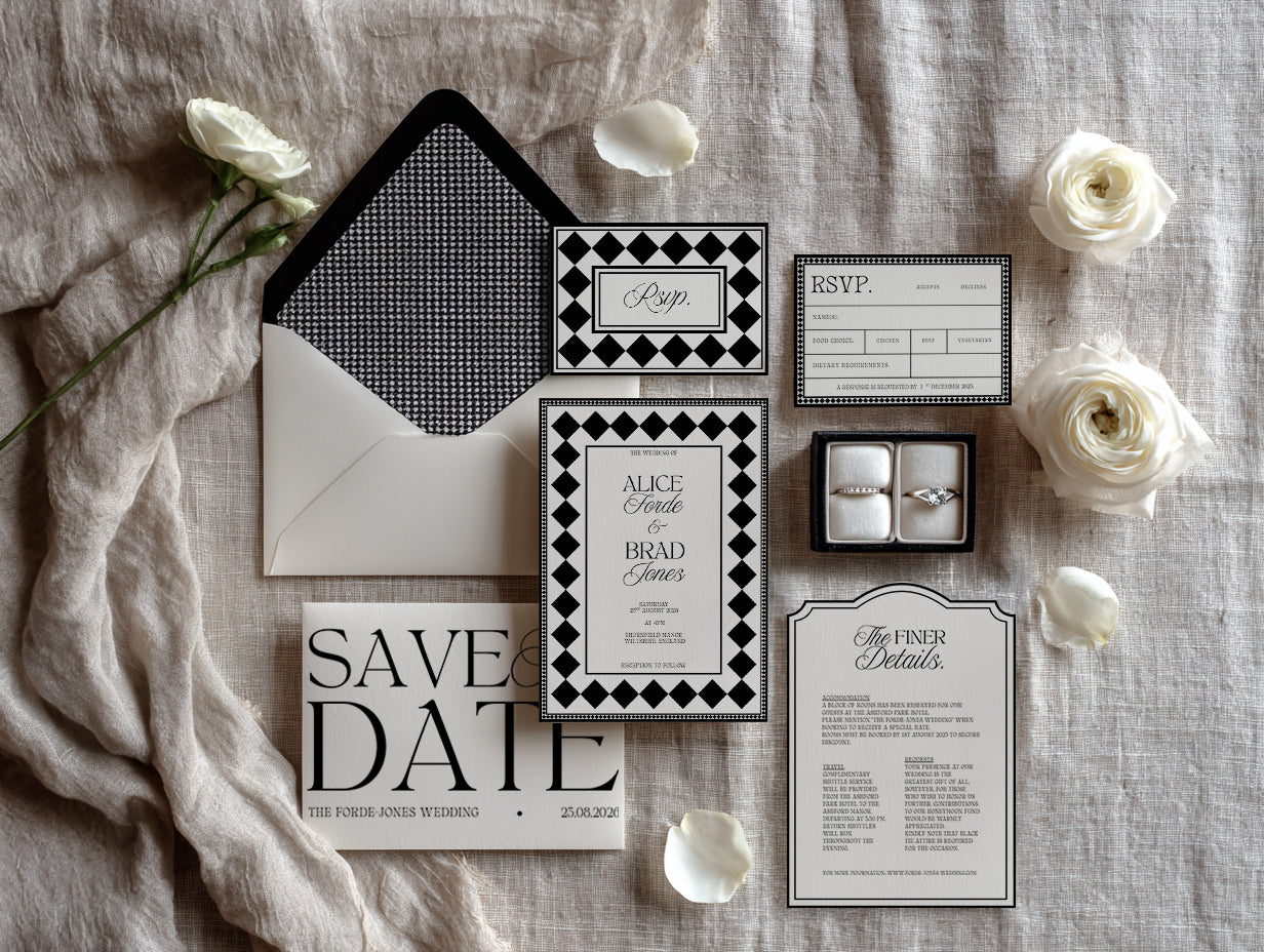 Luxury black and ivory wedding invitation and details card from The Madison Edit, featuring classic serif typography and checkerboard liner, flat lay styling.